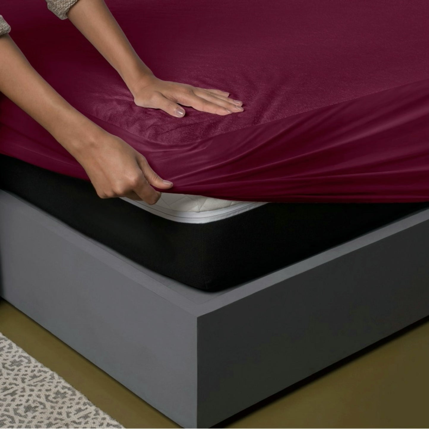 Uchuu's waterproof mattress cover in maroon color.